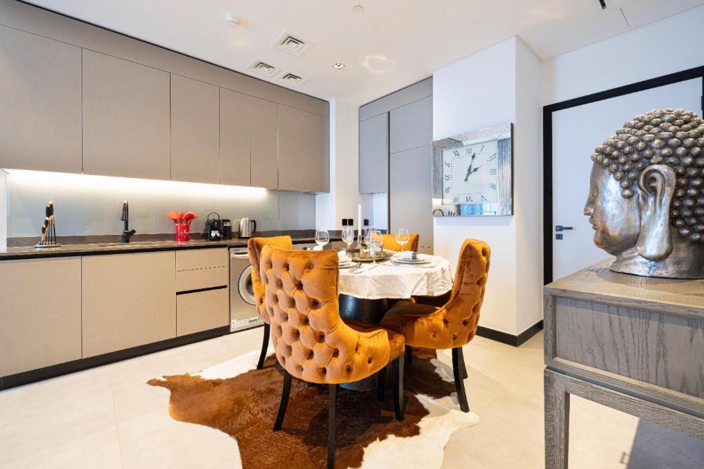 Kitchen and dining area with orange velvet chairs and sculptural decor