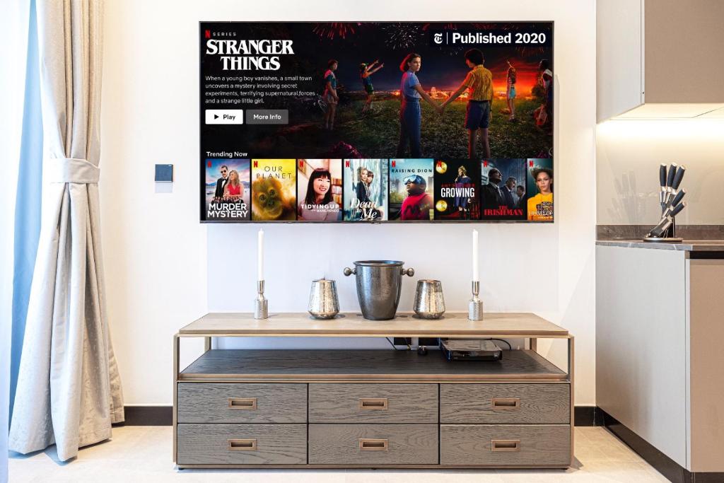 Living room media wall with wall-mounted TV and styled console