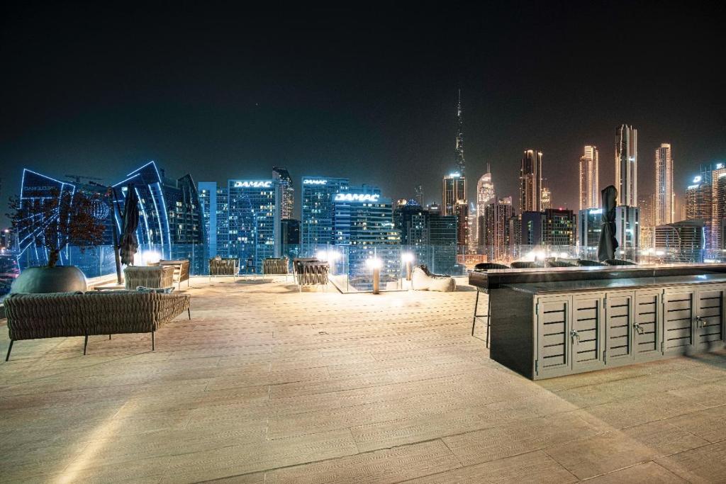 Rooftop terrace lounge seating with the Business Bay skyline at night