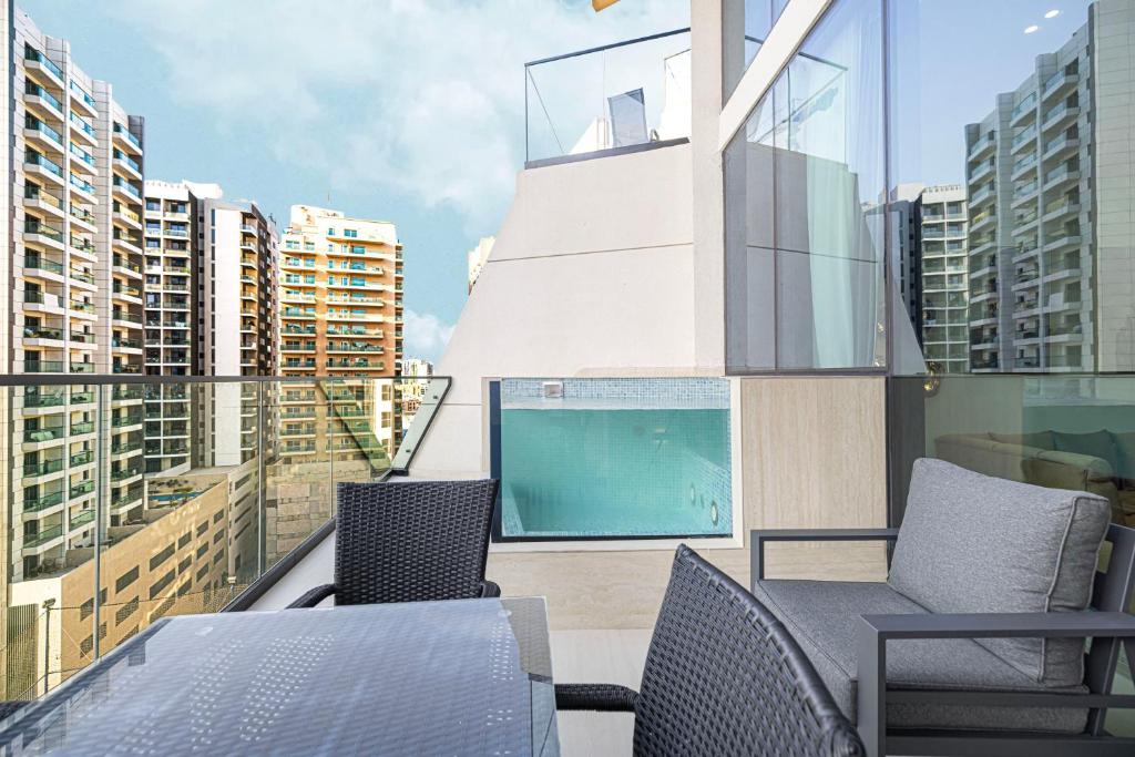 Private balcony with plunge pool, lounge seating and tower views
