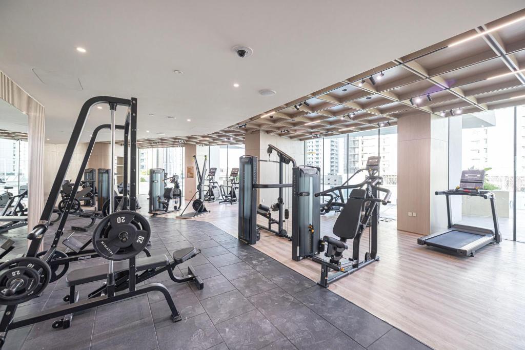 Gym with weight machines, cardio equipment and skyline views