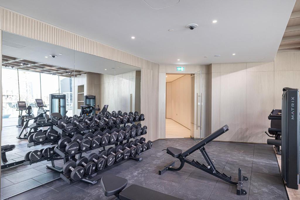 Fitness center with dumbbell rack, bench and Matrix machines