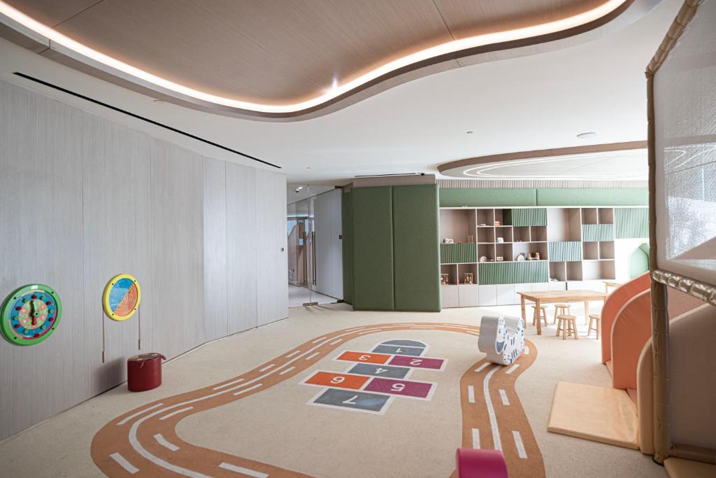 Children's play area with hopscotch and road-track floor and wall games