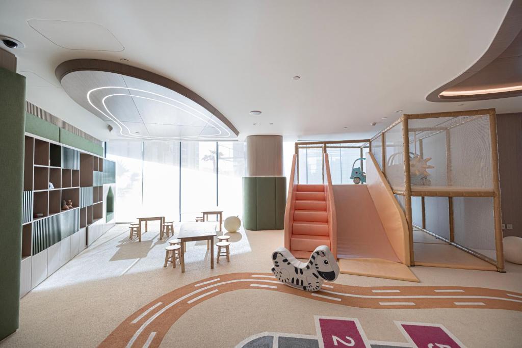 Indoor kids' playground with slide, zebra rocker and climbing frame